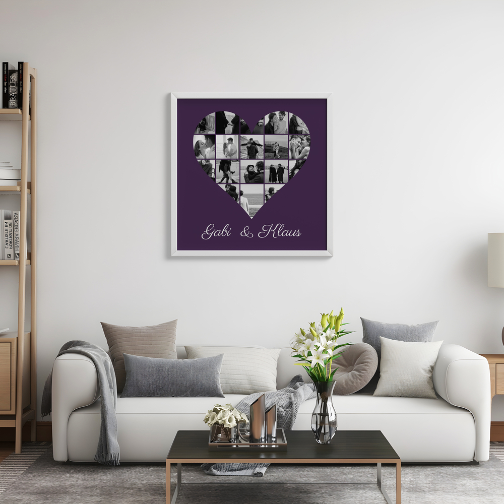 Fotocollage in Herzform mit Schwarz-Weiß-Fotos und Namen im weißen Rahmen über dem hellen Sofa im Wohnzimmer